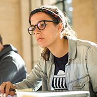 Girl with glasses looking forward.