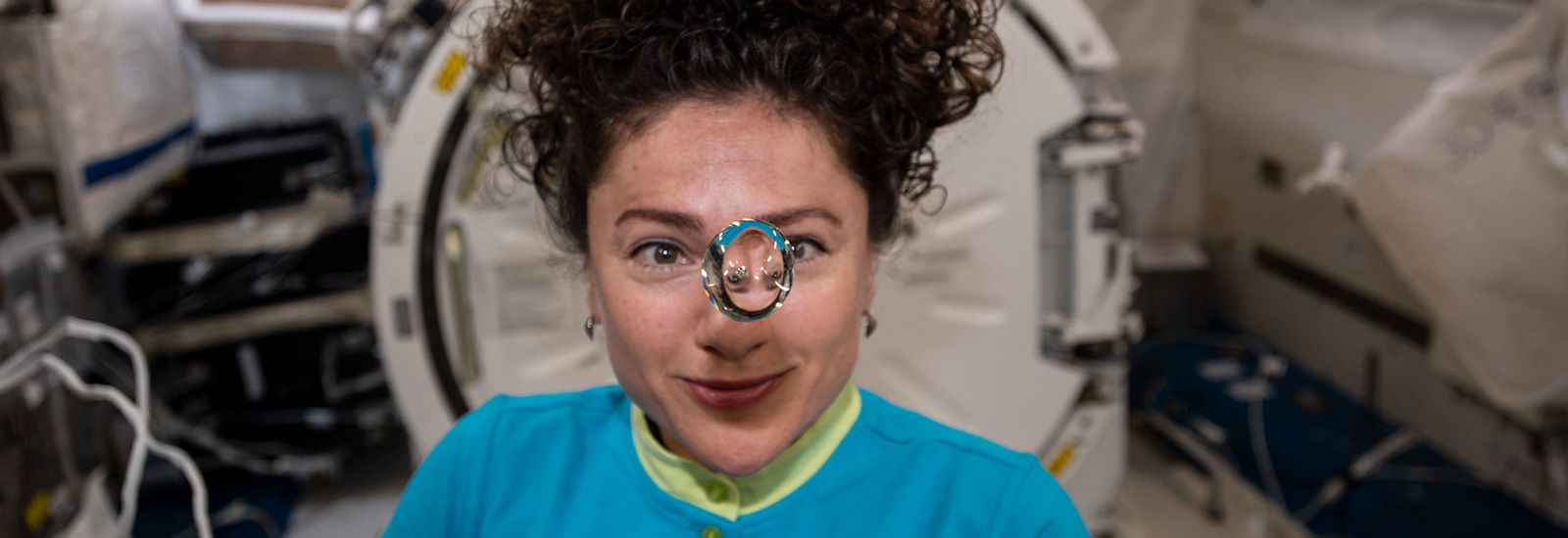 A scientist staring at a floating bubble in a lab