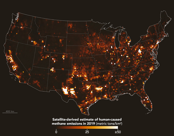 A satellite viewpoint of the United States in black with state outline overlays has a pixelated colorscale overlay indicating how much methane was released in a given area that ranges from black or dark brown into brassier colors until you reach white. While most of the map is a very dark shade, indicating little methane emissions, there are a few spots on the map that range into, or very nearly reach a white coloration. The two most significant of these white spots in size and lightness are in Texas Eastern and Western Borders. Other large population centers also show elevated levels such as the California Valley and Bay Area.