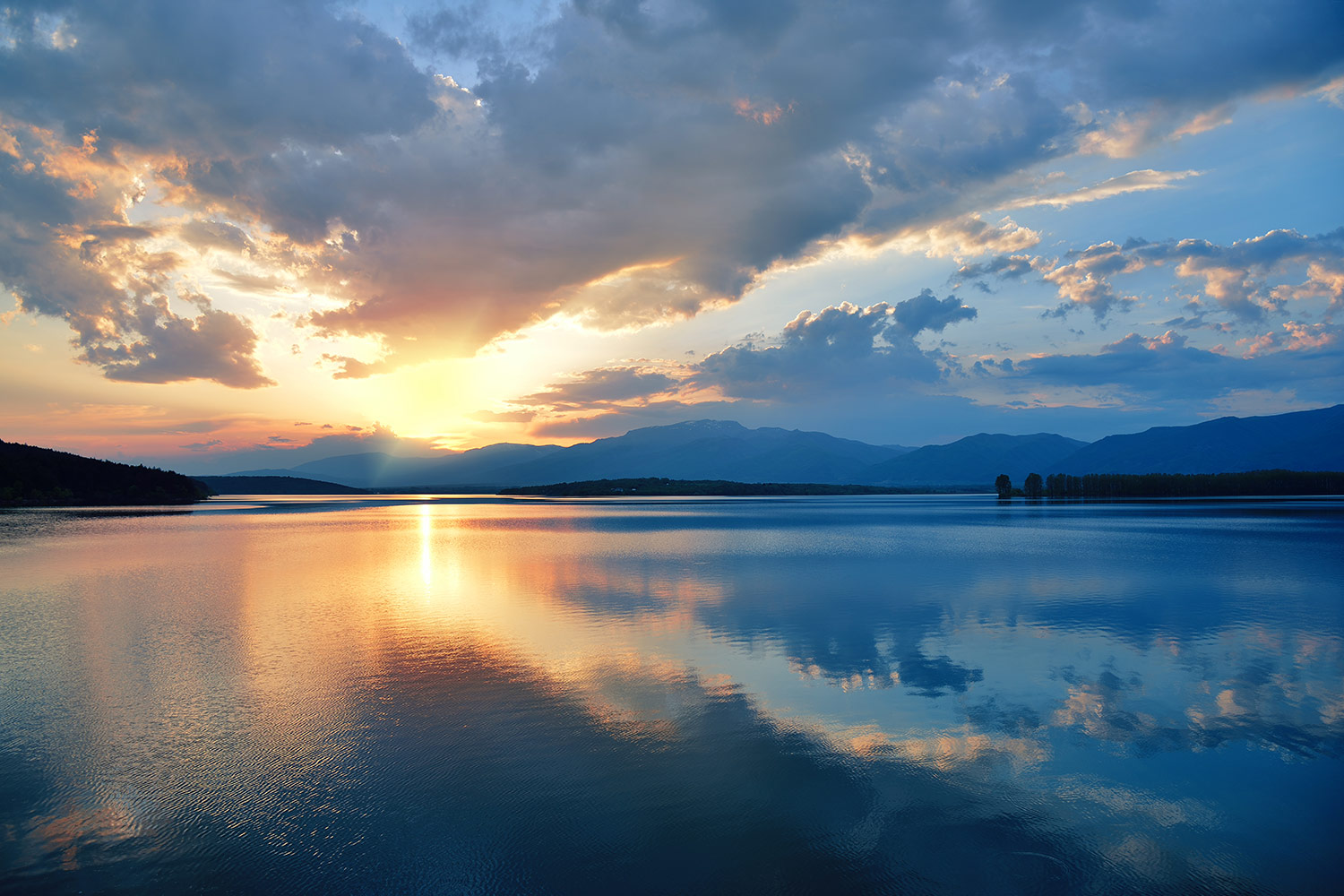 Sunset reflection over serene lake.