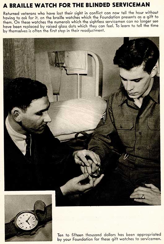 A blind, white veteran in uniform feels the tactile face of a braille watch. His hand is guided by a white man seated beside him. A metal army-style bed is visible behind them. A smaller photograph has a close-up of the watch face.