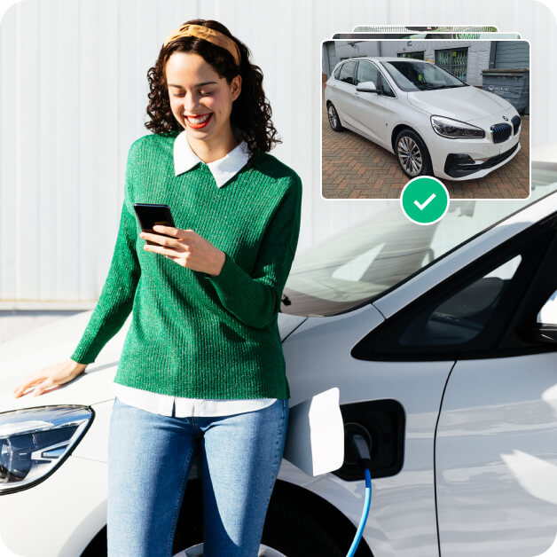 Woman standing by electric vehicle while using Motorway app