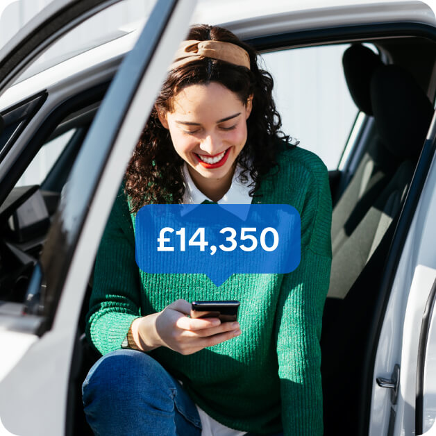 Woman sitting in electric vehicle while using Motorway app'