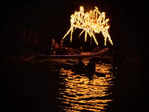 Boats and torches light up the river at COEP's Regatta