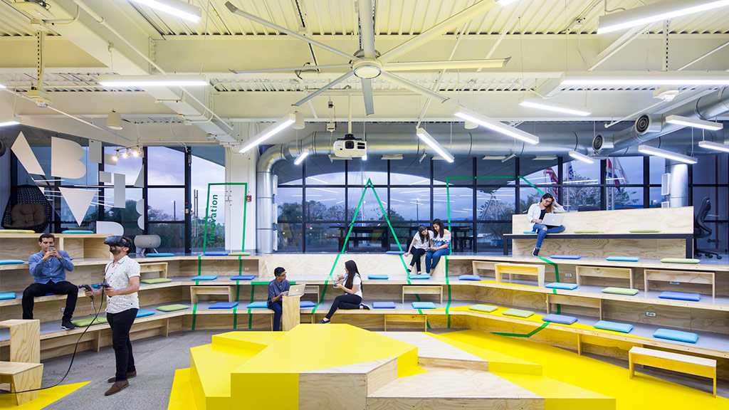 People sitting on yellow and blue blocks.