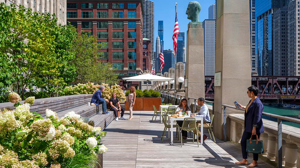 People sitting at tables outside.