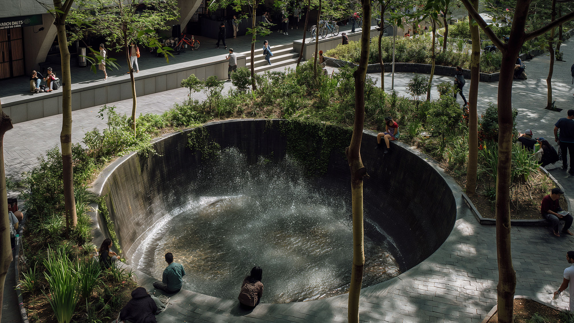 A group of people around a water fountain.