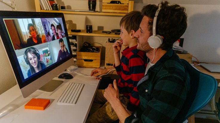 Photo of a man and child on a video call.