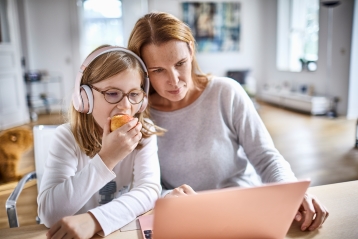 A mother and daughter looking at a PC