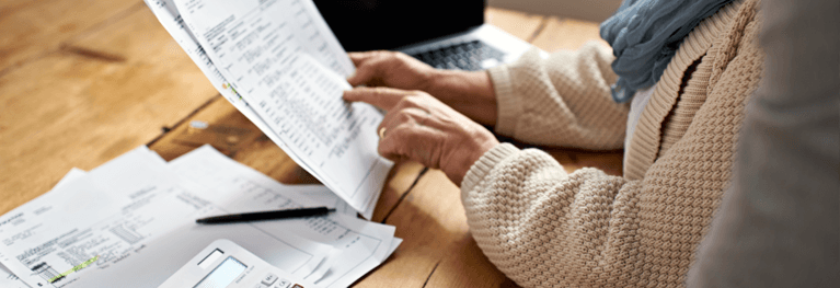 Senior woman receiving help with her finances from another person