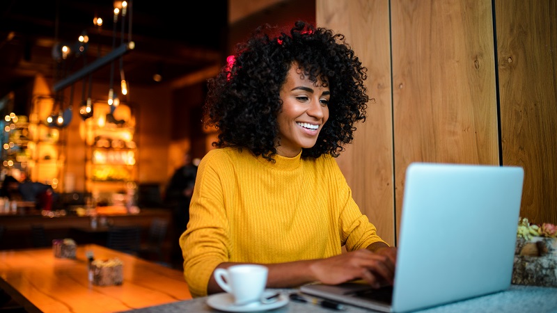 photo of a woman at a cafe on her laptop