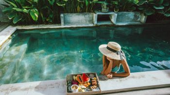 woman with hat in eco friendly pool